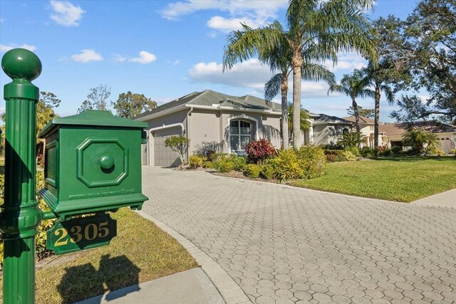 view of front facade featuring a front yard and a garage