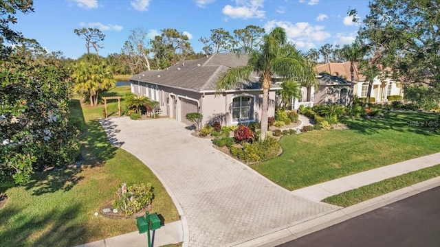 view of front facade with a garage and a front lawn