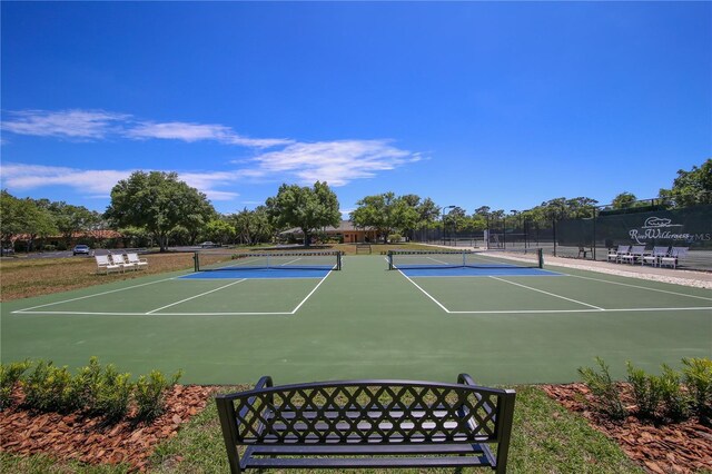 view of tennis court featuring basketball court