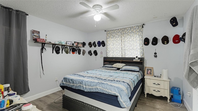 bedroom featuring ceiling fan, dark hardwood / wood-style floors, and a textured ceiling