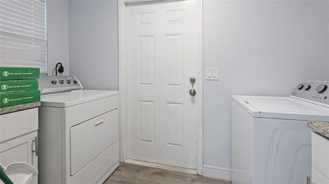 washroom with washing machine and dryer and wood-type flooring