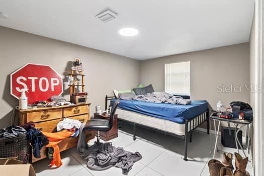 bedroom with tile patterned floors