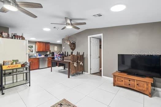 interior space featuring ceiling fan and lofted ceiling