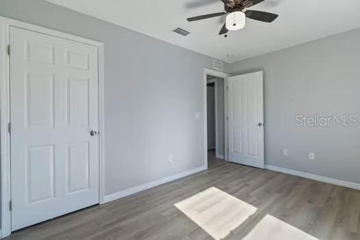 unfurnished bedroom featuring light wood-type flooring and ceiling fan