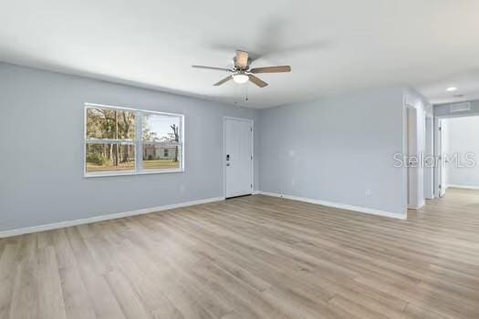 spare room with ceiling fan and light hardwood / wood-style floors