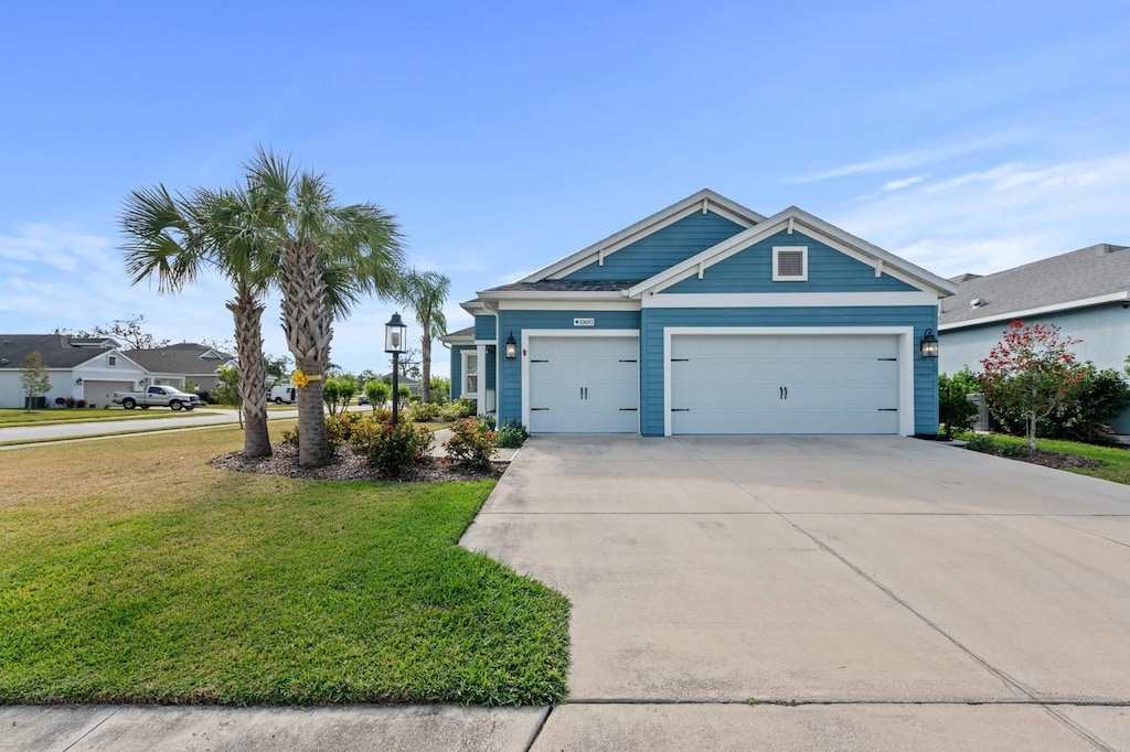 view of front of house featuring a garage and a front yard