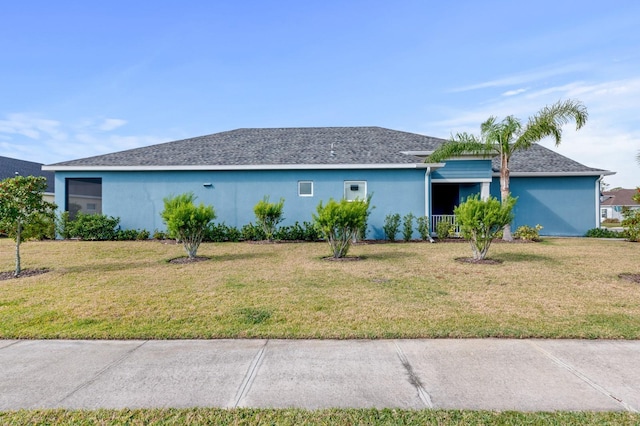 view of front of house featuring covered porch and a front lawn