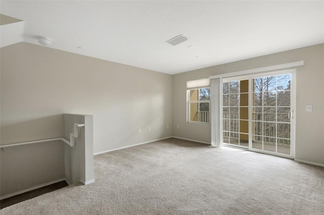 carpeted empty room featuring lofted ceiling