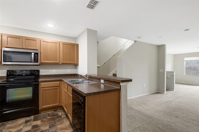 kitchen featuring sink, dark carpet, black appliances, and kitchen peninsula