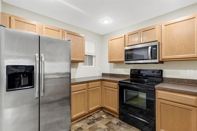 kitchen featuring stainless steel appliances and light brown cabinetry