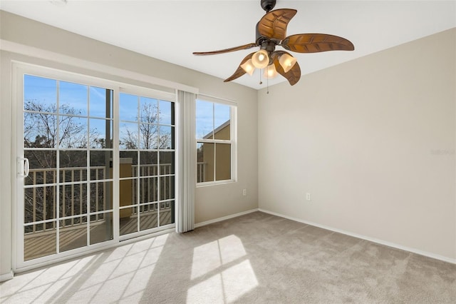 carpeted empty room featuring ceiling fan