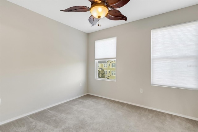 empty room featuring light carpet and ceiling fan