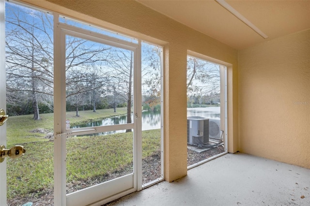 entryway with concrete floors and a water view