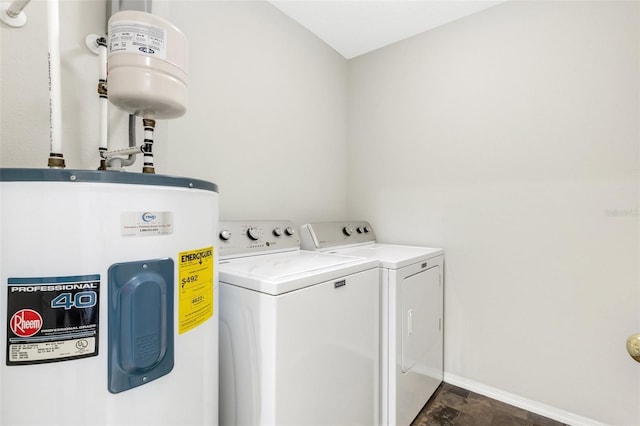 clothes washing area with washer and clothes dryer and water heater