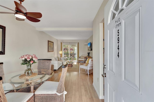 foyer featuring ceiling fan, beamed ceiling, and light wood-type flooring