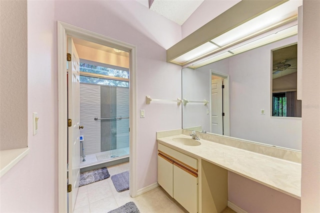 bathroom featuring tile patterned flooring, vanity, walk in shower, and lofted ceiling