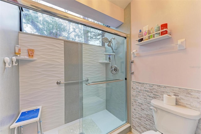 bathroom featuring toilet, tile walls, and walk in shower