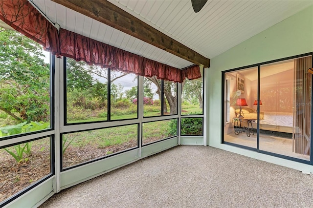 unfurnished sunroom with vaulted ceiling with beams, ceiling fan, and wooden ceiling