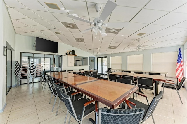 tiled dining area with a paneled ceiling