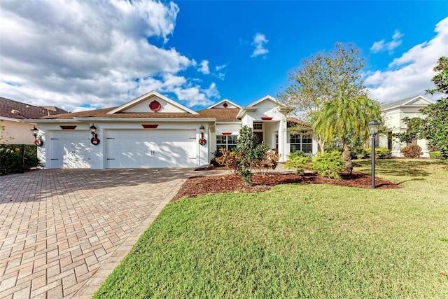 view of front of home featuring a garage and a front lawn