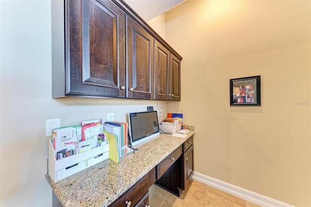 office area featuring built in desk and light tile patterned floors