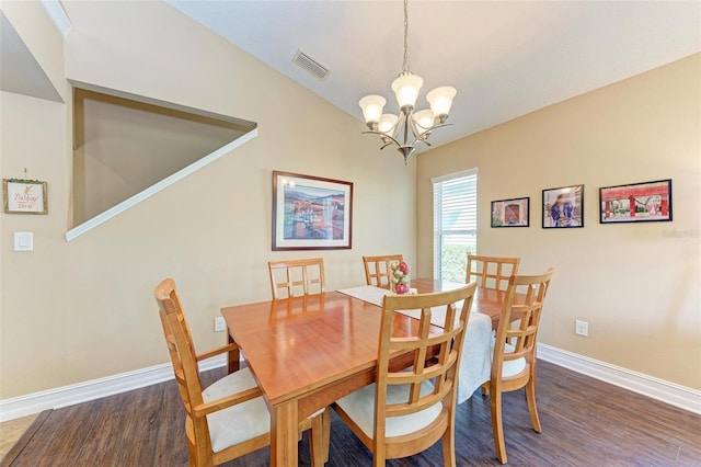 dining space with lofted ceiling, a chandelier, and dark hardwood / wood-style floors