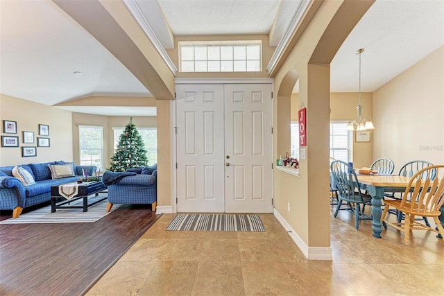 entrance foyer with an inviting chandelier and light hardwood / wood-style flooring