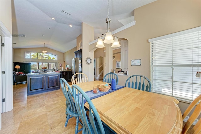 dining room featuring ceiling fan, ornamental molding, and lofted ceiling