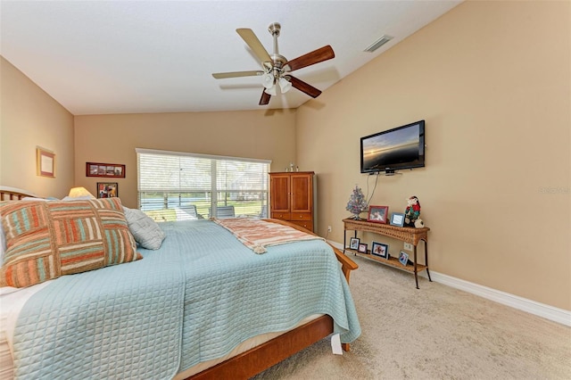 bedroom with ceiling fan, light colored carpet, and vaulted ceiling