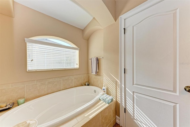 bathroom featuring a relaxing tiled tub