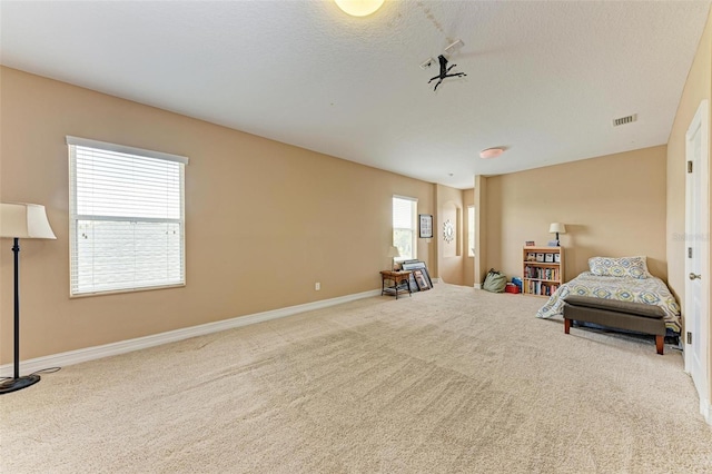 sitting room with carpet floors and a wealth of natural light