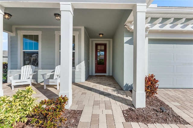 entrance to property with a porch and a garage