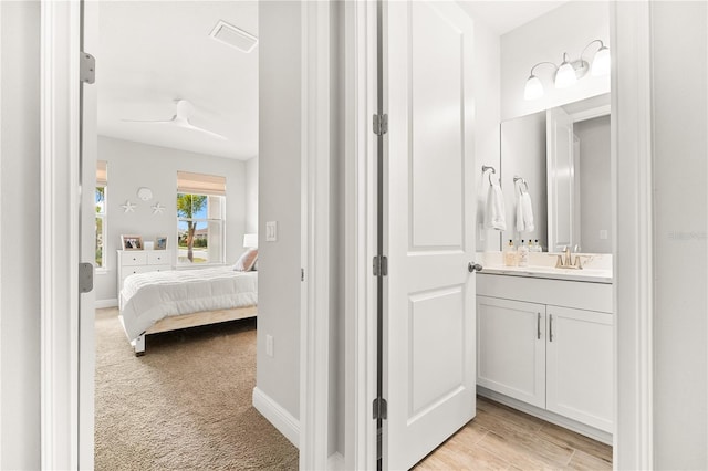 bathroom with ceiling fan and vanity