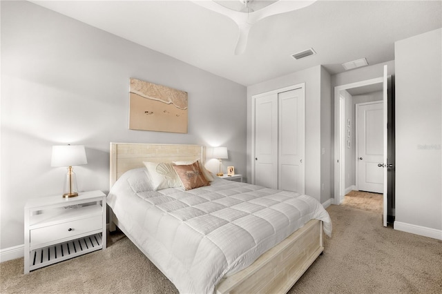 carpeted bedroom with ceiling fan and a closet