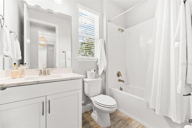 full bathroom with shower / tub combo, vanity, toilet, and hardwood / wood-style floors