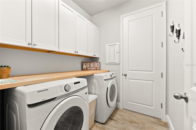 washroom featuring cabinets and washing machine and clothes dryer