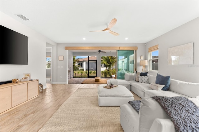 living room with plenty of natural light and ceiling fan