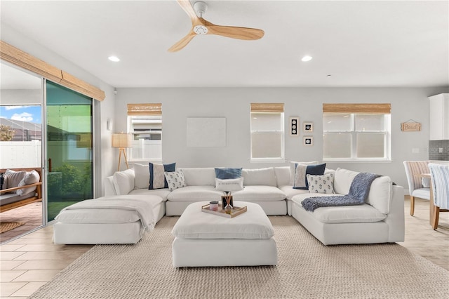 living room with a wealth of natural light and ceiling fan