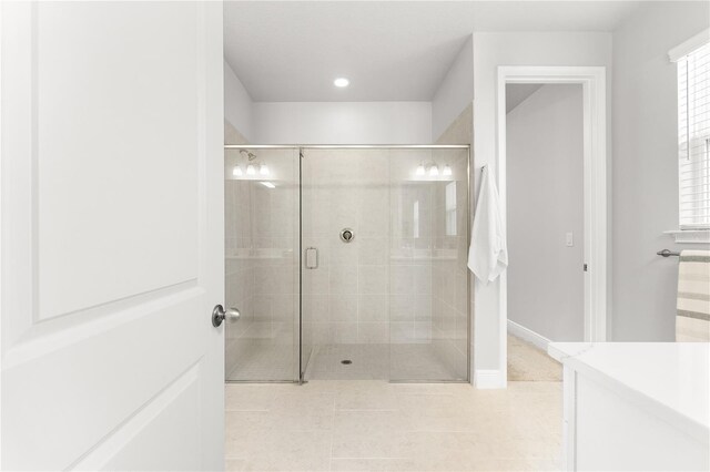 bathroom featuring vanity and a shower with door