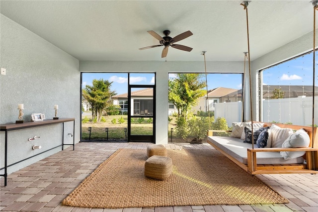 sunroom / solarium with ceiling fan