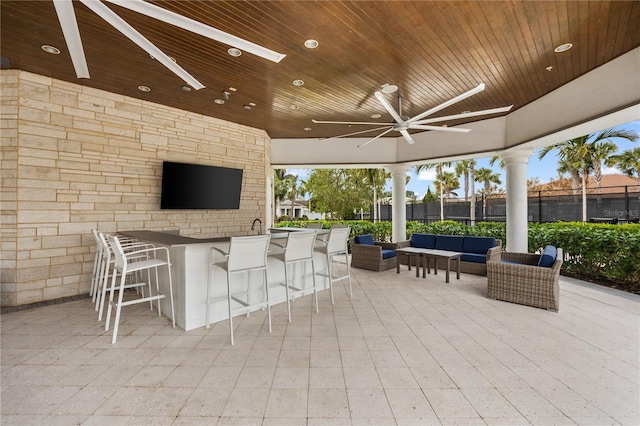 view of patio / terrace featuring ceiling fan, an outdoor bar, and an outdoor hangout area