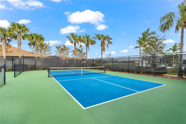 view of tennis court with basketball hoop