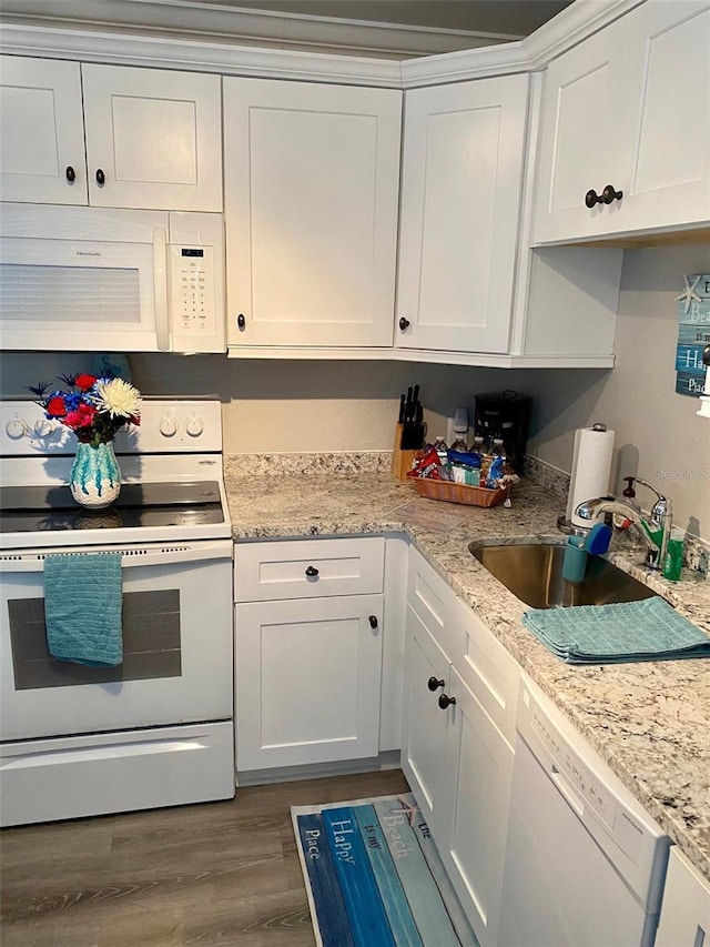 kitchen featuring white cabinets, dark hardwood / wood-style floors, sink, and white appliances