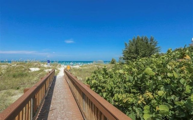 view of home's community featuring a view of the beach and a water view