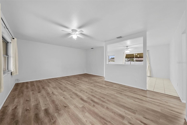 unfurnished living room featuring ceiling fan and light hardwood / wood-style flooring