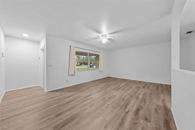 unfurnished room featuring light wood-type flooring and ceiling fan