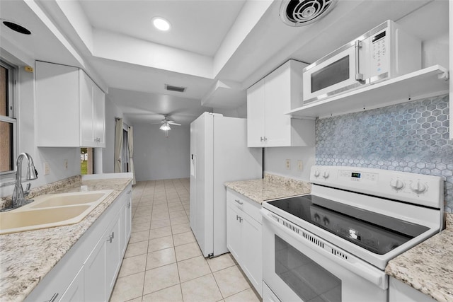 kitchen with white appliances, ceiling fan, white cabinets, and sink