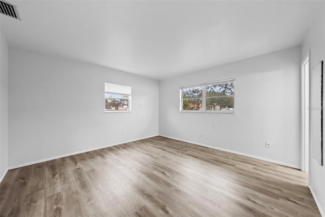 empty room with light hardwood / wood-style flooring