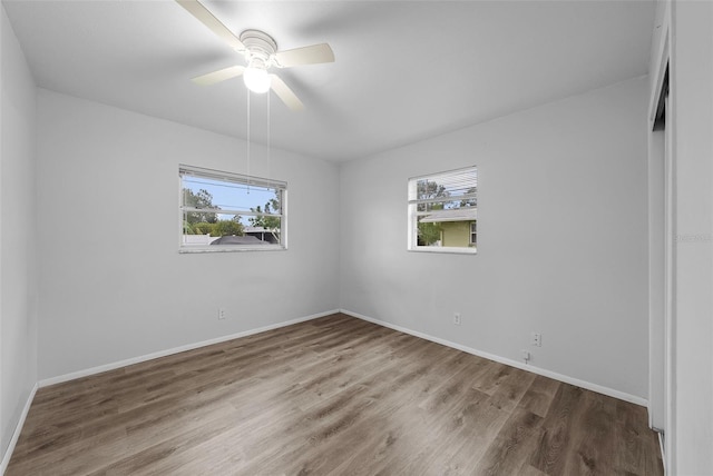 empty room with ceiling fan and hardwood / wood-style floors