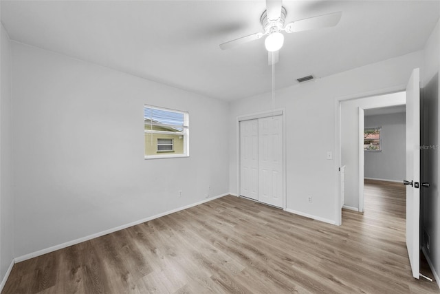 unfurnished bedroom with ceiling fan, light hardwood / wood-style floors, and a closet